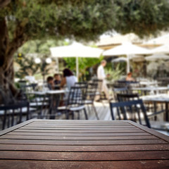 Wooden desk of free space and summer bar background 