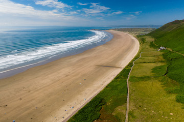 Aerial view of a huge, golden sandy beach and ocean surf
