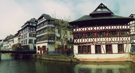 Fototapeta premium Beautiful panorama timber framing houses, Fachwerk architecture on picturesque canals of Strasbourg
