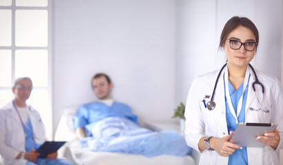 Doctor checking heart beat of patient in bed with stethoscope