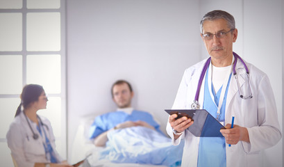 Doctor checking heart beat of patient in bed with stethoscope