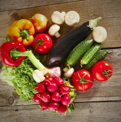 Composition with assorted raw organic vegetables wooden table