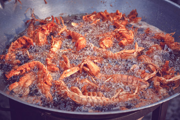 King shrimp tails cooking. Close up of Frying Shrimps in the fryer in hot oil.