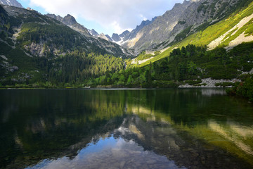 Naklejka na ściany i meble The beautiful lake Popradske pleso in the High Tatras in the evening sun.