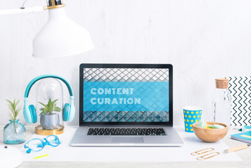 Computer staying on a table & showing the screen. Trendy & vibrant design. Geometry. Innovational digital internet applications & web business solutions. Modern workspace in an office. Development.