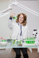 Fototapeta premium Portrait of middle age woman working in microbiology industry