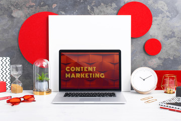 Computer staying on a table & showing the screen. Trendy & vibrant design. Geometry. Innovational digital internet applications & web business solutions. Modern workspace in an office. Development.