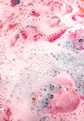 The bright bath bomb dissolves in water .