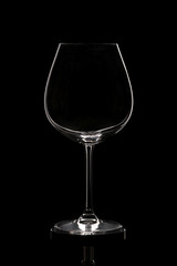 Empty tall wine glass on a black background