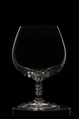 Empty cognac glass on a black background