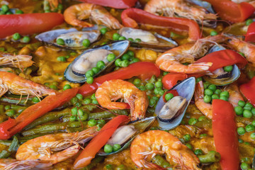 Spanish seafood paella in fry pan with mussels, shrimps and vegetables