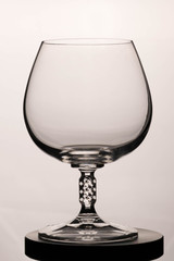 Empty cognac glass on a white background