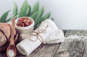 Spa and wellness setting with flowers and towels. Bright composition with tropical flowers. Dayspa nature products with coconut