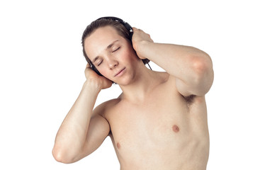 Handsome naked young man in towel listening to music in headphones on white background isolated