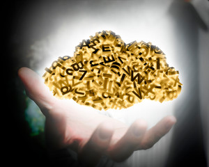 Businessman hand holding self-illuminated big data cloud of 3d characters.
