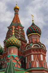 Fototapeta na wymiar Saint Basil´s colorful domes, with grey clouds background, Moscow, Russia