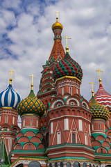 Fototapeta na wymiar Saint Basil´s colorful domes, with grey clouds background, Moscow, Russia