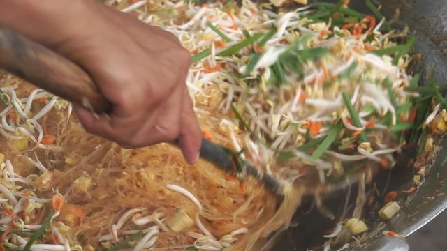 Asian Street food: Chef Cooking Pad Thai, Street food : thai man is cooking pad thai noodle with egg at night food market in Thailand