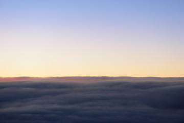 The blue skyline with cloudy in sunrise time, view from window on the plane.