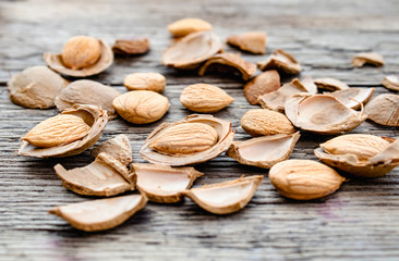 The core of apricots and stones on the background of old boards. Apricot pits for the manufacture of tablets and drugs.