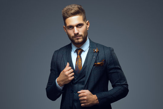 Stylish young man in suit and tie. Business style. Fashionable image. Office worker. Sexy man standing and looking at the camera