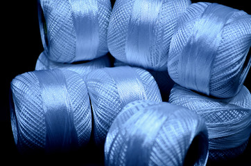 
Threads on a black canvas background. White threads.