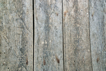 Close-up of wooden door with rusty nails. Rough wood grain