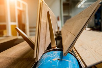 Production line of the wooden floor factory. CNC automatic woodworking machine.