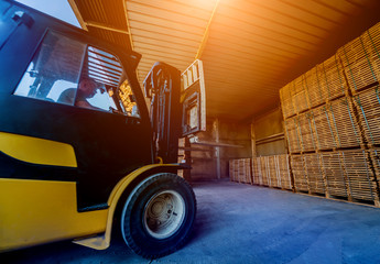 Forklift loader load lumber into a dry kiln. Wood drying in containers.