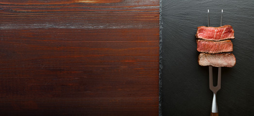 Three pieces of meat on a fork for meat. three types of meat roasting, rare, medium,well done.