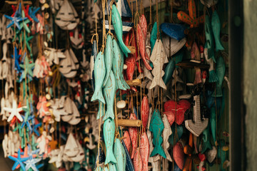 Handmade wooden mobile souvenirs hanging in Bali shop