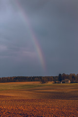 Almost invisible rainbow in the countryside
