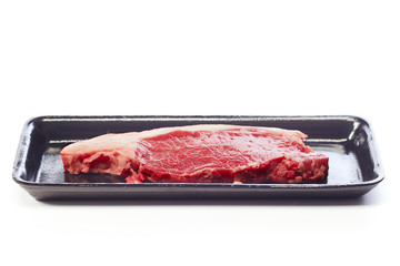 raw beef steak in vacuum package on