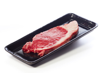 raw beef steak in  package on white