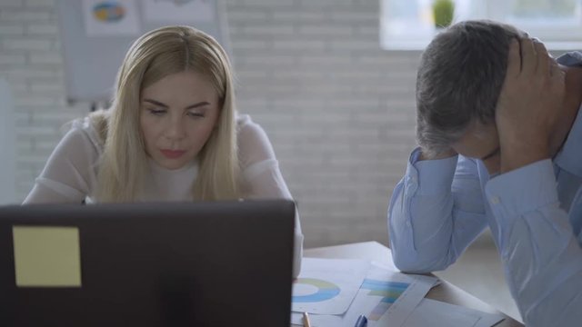 two tired businessmen in the office worry about the future of the company. partners fiasco deal bargain 4K