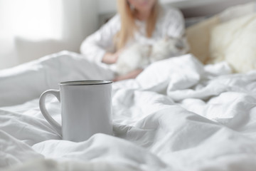 Good morning concept blonde girl with the cat and coffee cup hygge lagom concept. Horizontal copyspace