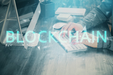 Blockchain theme hud with businessman working on computer on background. Concept of crypto chain....