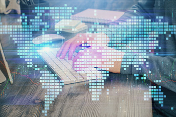 Double exposure of businessman working on laptop on background. International business hologram in front. Concept of success.