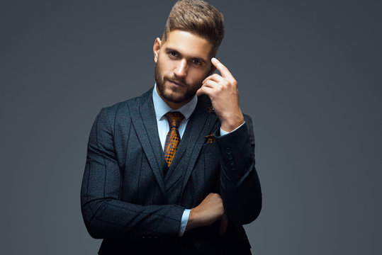 Stylish young man in suit and tie. Business style. Fashionable image. Office worker. Sexy man standing and looking at the camera