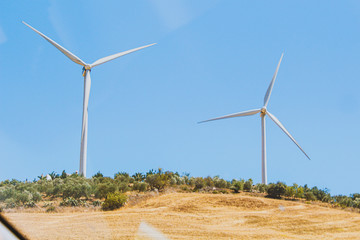 wind power plant windmill energy electricity on the yellow hills soft selective focus