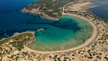 Fototapeta premium Aerial drone view of semicircular sandy beach and lagoon of Voidokilia, one of the most iconic beaches in Mediterranean sea, with crystal clear turquoise sea, Messinia, Greece