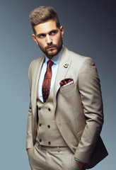 Stylish young man in suit and tie. Business style. Fashionable image. Office worker. Sexy man standing and looking at the camera