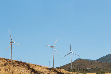 wind power plant windmill energy electricity on the yellow hills soft selective focus
