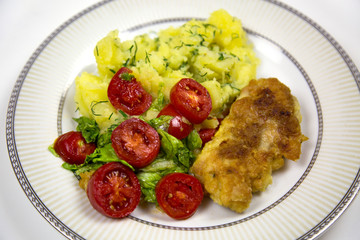 Thigh deep-fried chicken potatoes tomatoes on plate isolated on white background Food Products