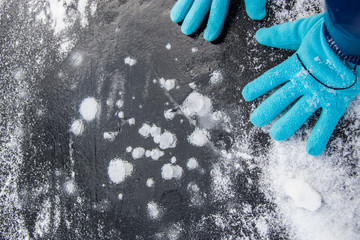 Blue gloves on the background of bubbles in the ice