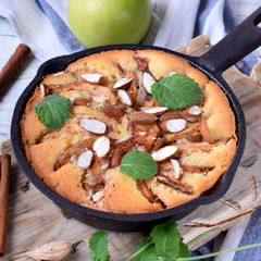 Norwegian pie with apples and almonds in a cast iron pan