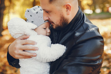 Family with cute son. Father in a black jacket.