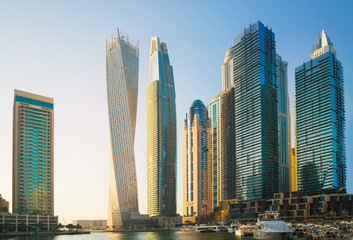 Obraz na płótnie Canvas Dubai, UAE United Arabs Emirates. Dubai marina skyscrapers and yachts at sunset. Apartments, hotels and office buildings, modern residential development of UAE