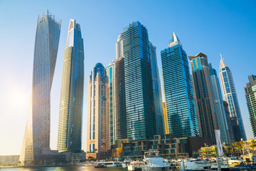 Obraz na płótnie Canvas Dubai, UAE United Arabs Emirates. Dubai marina skyscrapers and yachts at sunset. Apartments, hotels and office buildings, modern residential development of UAE