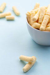 Crunchy corn puffs, pufuleti in white bowl